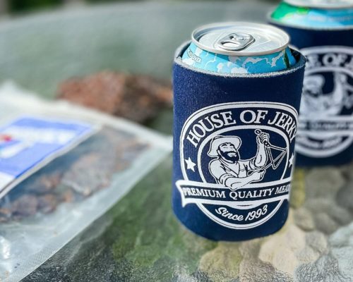 House of Jerky blue cozi around a can beside some jerky on a table