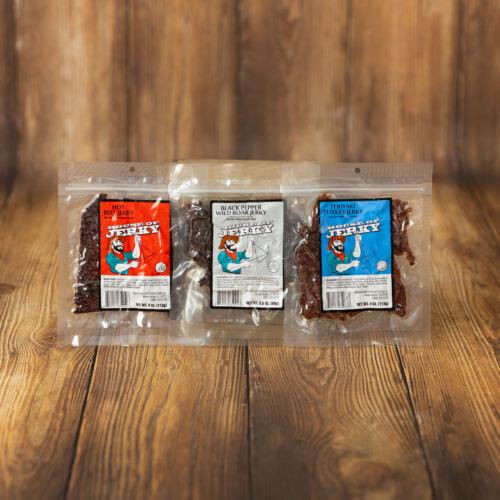 3 bags of jerky in front of a wood background